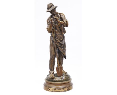 A French bronze statuette of a gardener lighting his pipe, c1900, cast from a model by Maurice Constant, even light brown pat