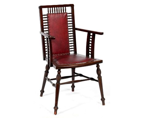 A mahogany elbow chair, early 20th c, the padded splat in spindle surround, with matching arm supports and padded seat, on sl