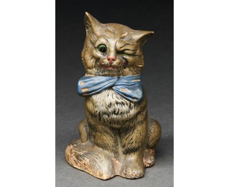 A cold painted terracotta model of a winking cat in a blue bow, late 19th c, 13cm h  One ear slightly chipped, small spots of