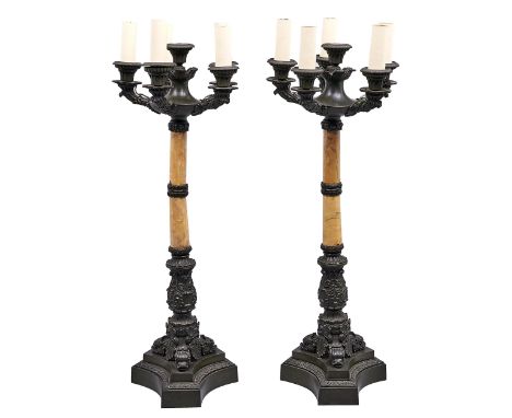 A pair of French bronze mounted marmo giallo Siena candelabra, late 19th c, of six lights, the fluted sconce on leafy scrolli