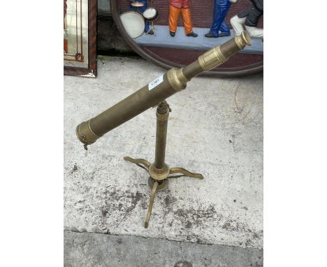A VINTAGE BRASS TELESCOPE ON A TRIPOD STAND 