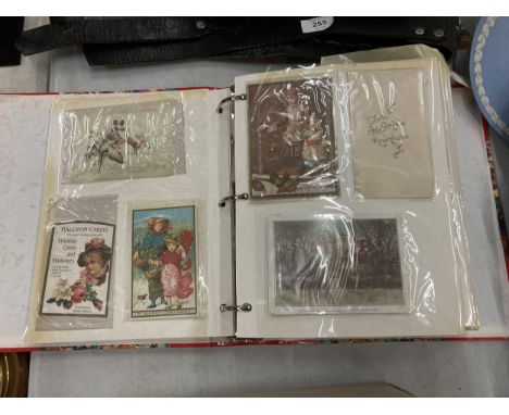 A VINTAGE POSTCARD ALBUM WITH ASSORTED CARDS 