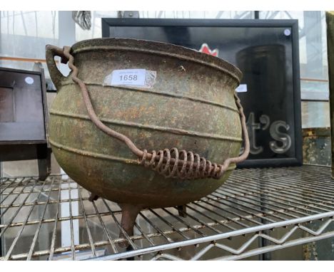 A VINTAGE CAST IRON TRI FOOTED CAULDRON 
