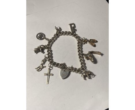 A SILVER CHARM BRACELET WITH NINE CHARMS AND A HEART PADLOCK 