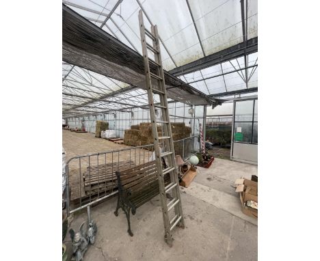 A TWO SECTION ALUMINIUM 26 RUNG EXTENDING LADDER 