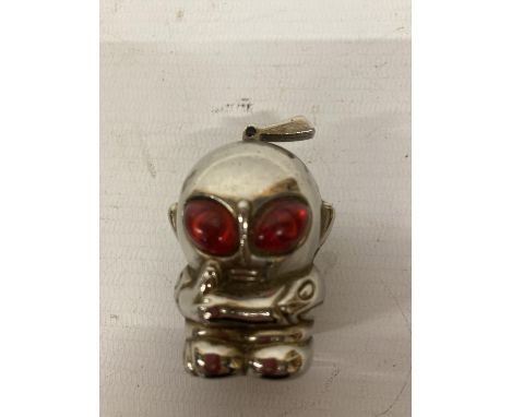 A VINTAGE WHITE METAL LIGHTER IN THE SHAPE OF AN ALIEN WITH RED EYES, HEIGHT 5CM 