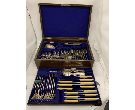 A VINTAGE OAK CASED WALKER AND HALL SILVER PLATED CANTEEN OF CUTLERY 