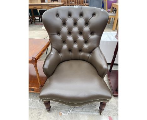 A VICTORIAN STYLE BUTTON BACK LOUNGE CHAIR ON TURNED FRONT LEGS 