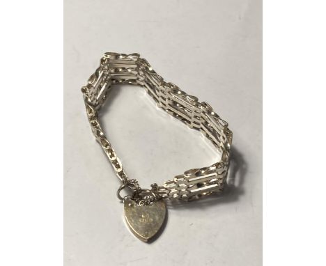 A SILVER FIVE BAR GATE BRACELET WITH HEART PADLOCK 