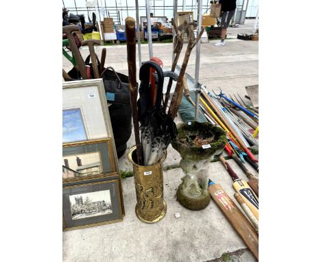 A BRASS STICK STAND AND AN ASSORTMENT OF WALKING STICKS 