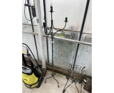 A DECORATIVE WROUGHT IRON CANDLESTICK STAND 