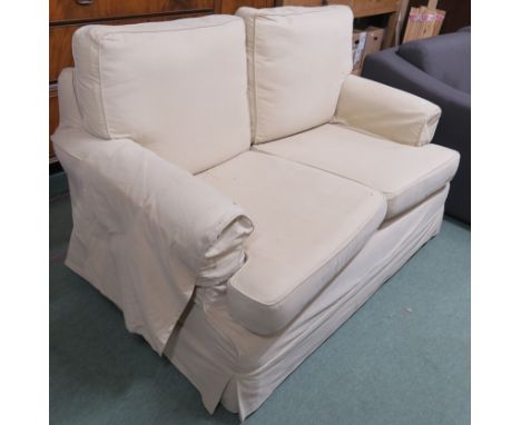 A two seater sofa with cream covers, 92cm high x 150cm wide x 95cm deep Condition Report: Available upon request