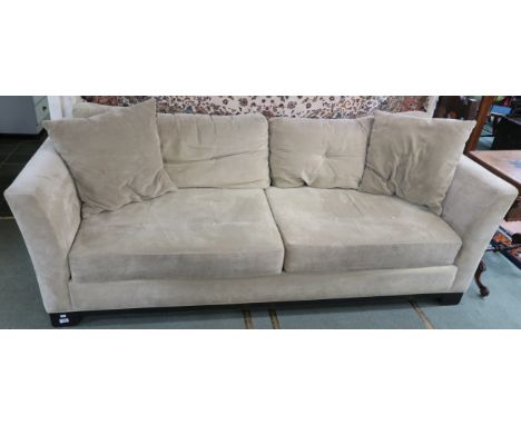 A light olive green upholstered three seater sofa retailed by Macy`s New York, 73cm high x 226cm wide x 96cm deep Condition R