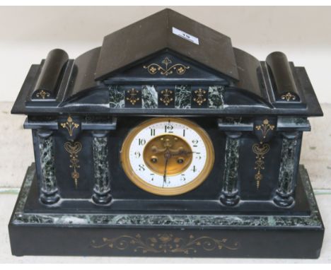 A black slate mantel clock and a wall clock (2) Condition Report: The mantel clock is in good general condition consummate wi