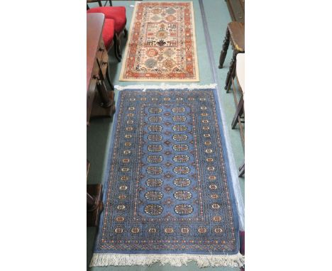 A Blue ground Bokhara rug, 166cm x 93cm, a modern Kazak wool rug, 157cm x 80cm , a Turkish rug with geometric design, 215cm x