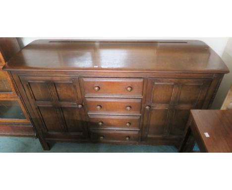 A dark Ercol sideboard with four drawers flanked by two doors, 90cm high x 147cm wide x 52cm deep Condition Report: Available