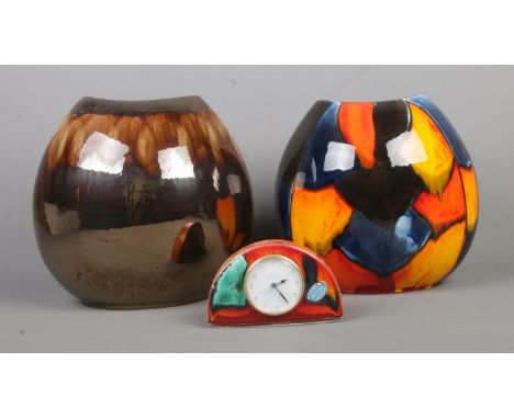 A collection of Poole pottery, including purse vases and clock. Tallest: 26cm high.  