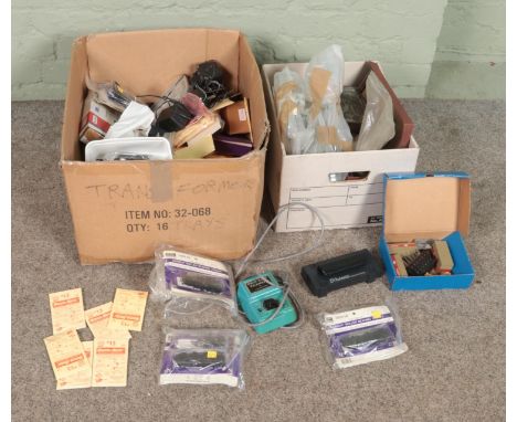 Two boxes of assorted model railway spares and repairs, Kadee HO Gauge spares, Dynamis Command Station, etc.  