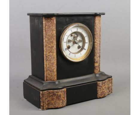 A black slate and marble mantel clock. Having Roman numeral markers. The movement stamped for Henry Marc, Paris and Marti.  M