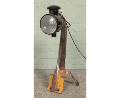 An industrial style upcycled lamp, with adjustable head, bracket base and spanner feet. Height: 77cm.  Working.