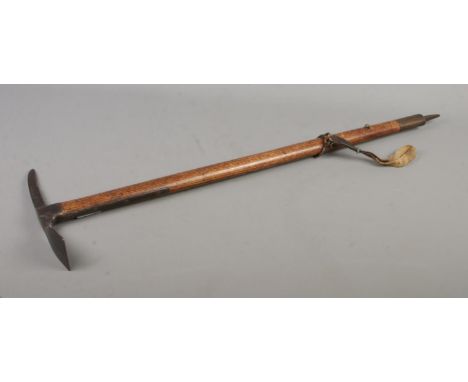 A second world war British military pickaxe with steel head produced by Cornelius Whitehouse LTD stamped with broad arrow sta
