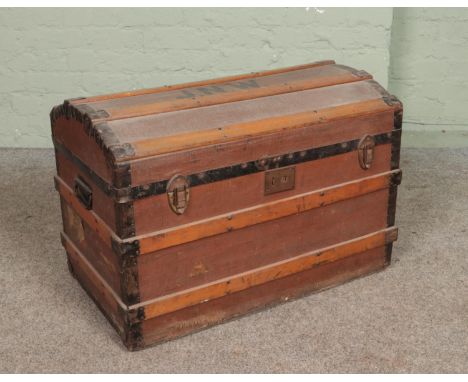 A vintage wood bound travel trunk. Stencilled to the top JNW.  