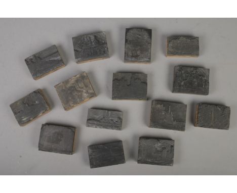 A collection of vintage printing blocks including landscape scenes and old buildings, some labelled to back with locations su