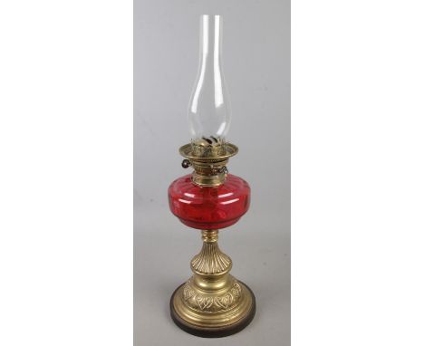 A Victorian Young's cranberry glass and brass oil lamp. (63cm)  