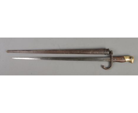 A French 1874 bayonet with scabbard. Inscribed to edge of blade and dated 1878. Blade length 52cm. CANNOT POST OVERSEAS  