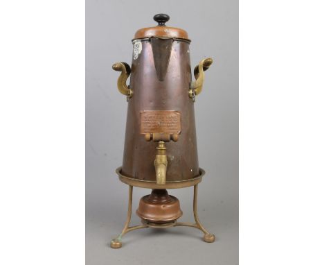 A copper and brass coffee pot, with burner and trivet. Labelled for Ash's Kaffeekanne, manufactured by the Piston Freezing Ma