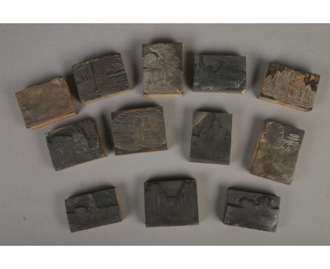 A collection of vintage printing blocks including landscape scenes and old buildings, some labelled to back with locations su