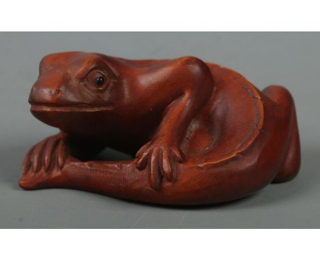 A hand carved hardwood netsuke of a lizard, signed to base.  