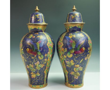 Exquisite pair of hand painted lidded porcelain vases, showcasing a vibrant palette of cobalt blue, emerald green, and gold. 
