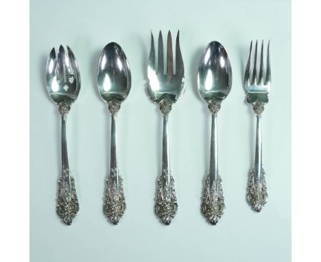 This five-piece Wallace sterling silver flatware set is crafted in the highly coveted Grande Baroque pattern, first introduce