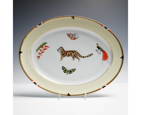 Designed by Lynn Chase and crafted by Porcel in Portugal, this porcelain platter features vivid depictions of exotic wildlife