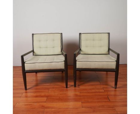 A pair of Mid Century Modern lounge chairs featuring sleek ebonized wood frames and angled legs, with ladder-back detail. The