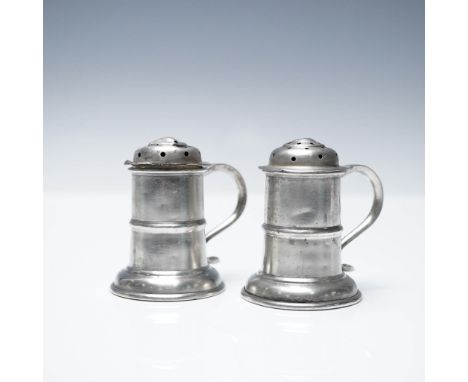 A pair of sterling silver salt and pepper shakers by F. Walter Lawrence, featuring a classic tankard-style design with curved