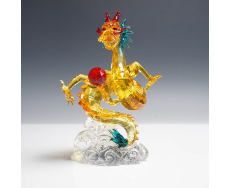 Swarovski crystal figurine titled Tutelary Spirit -Auspicious Dragon, depicting a powerful golden dragon coiled atop a swirli