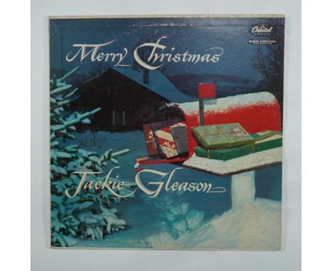 A vintage vinyl record of Merry Christmas by Jackie Gleason, released under Capitol Records (W-758). This classic holiday alb