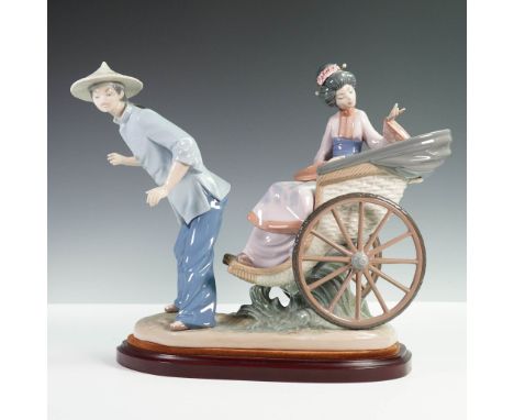 This intricately detailed sculpture features an elegant seated woman in traditional attire being pulled in a woven rickshaw b