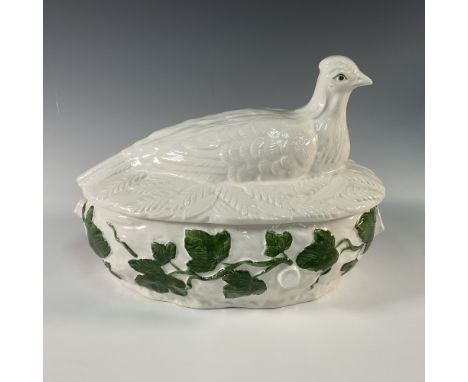 This charming ceramic tureen features a lidded design with a pheasant-shaped handle and vibrant green ivy accents. The lid is
