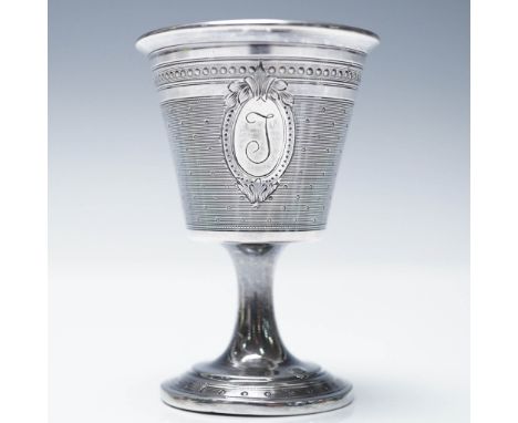 This silver egg cup features intricate engine-turned detailing with a decorative cartouche engraved with the letter 'J.' The 
