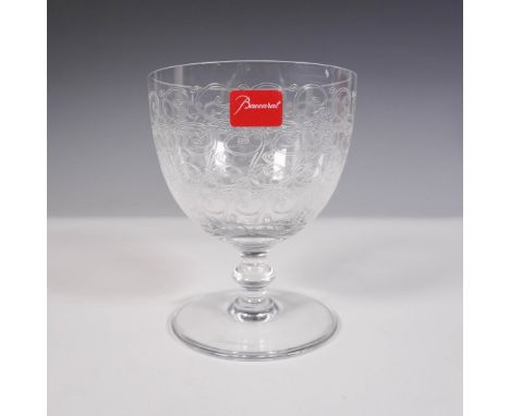 The goblet features etched scrollwork encompassing the bowl and is mounted on a clear, round wafer stem with a circular foot.