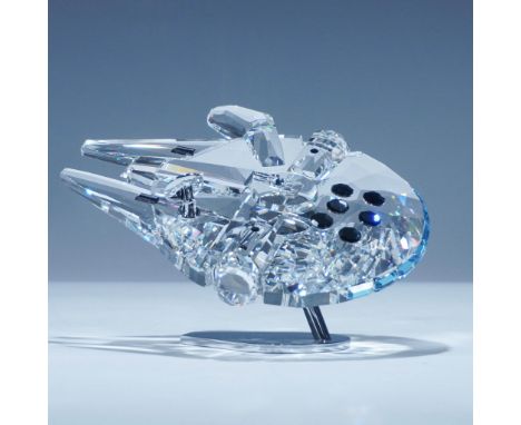 Swarovski crystal figurine depicting the Millennium Falcon from the Star Wars universe. This piece is crafted with 715 precis