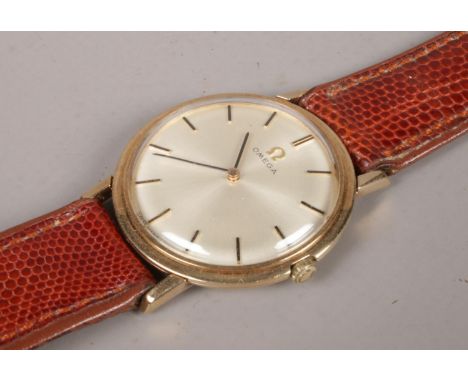 A gents 9ct gold Omega manual wristwatch on leather strap. Satin dial and baton markers.  Running.
