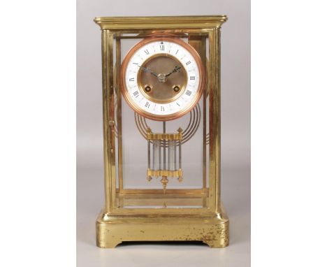 A brass and glass Japy Freres mantel clock. With Roman numeral markers, chiming on a coiled gong, and mercury pendulum. Movem