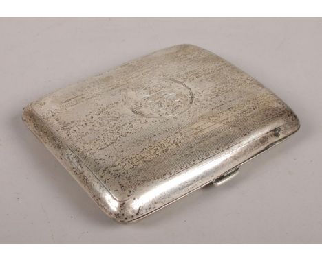 A silver hinged engine turned cigarette case, with circular cartouche to the front. Assayed in Birmingham, 1946, by S Blancke