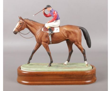 A Royal Worcester horse racing figure, titled The Winner, modelled by Doris Lindner. Dated 1959. Raised and inset on wooden p