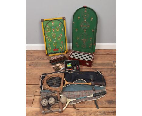 A collection of vintage games, to include bagatelle board, draughts and racket and ball set.  
