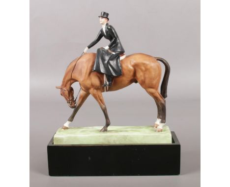 A Royal Worcester figure of a horse and rider, titled At The Meet, modelled by Doris Lindner. Number 3114. Raised and inset o